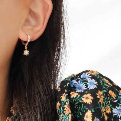 woman wearing gold mini hoop earring