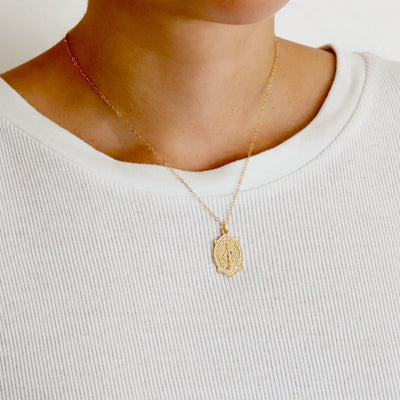 Gold religious pendant necklace